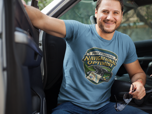 Man wearing a 'Professional Navigational Optimist' t-shirt sitting in a car.