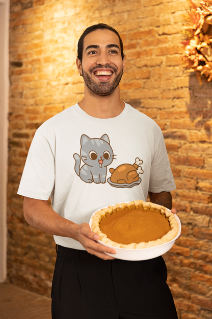 Thanksgiving Cat T-Shirt – Cute Hungry Cat and Turkey Tee shown on man in white shirt smiling with pumpkin pie in rustic fall setting