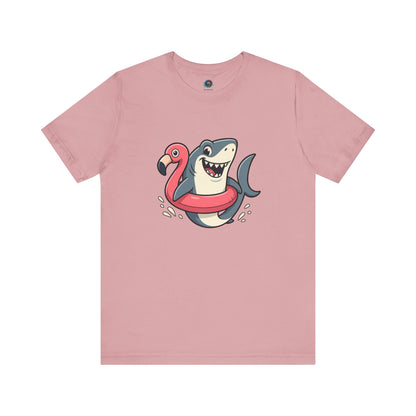 Shark Flamingo Floatie T-Shirt – Funny Beach & Pool Day Tee in orchid featuring grinning shark in pink flamingo pool ring