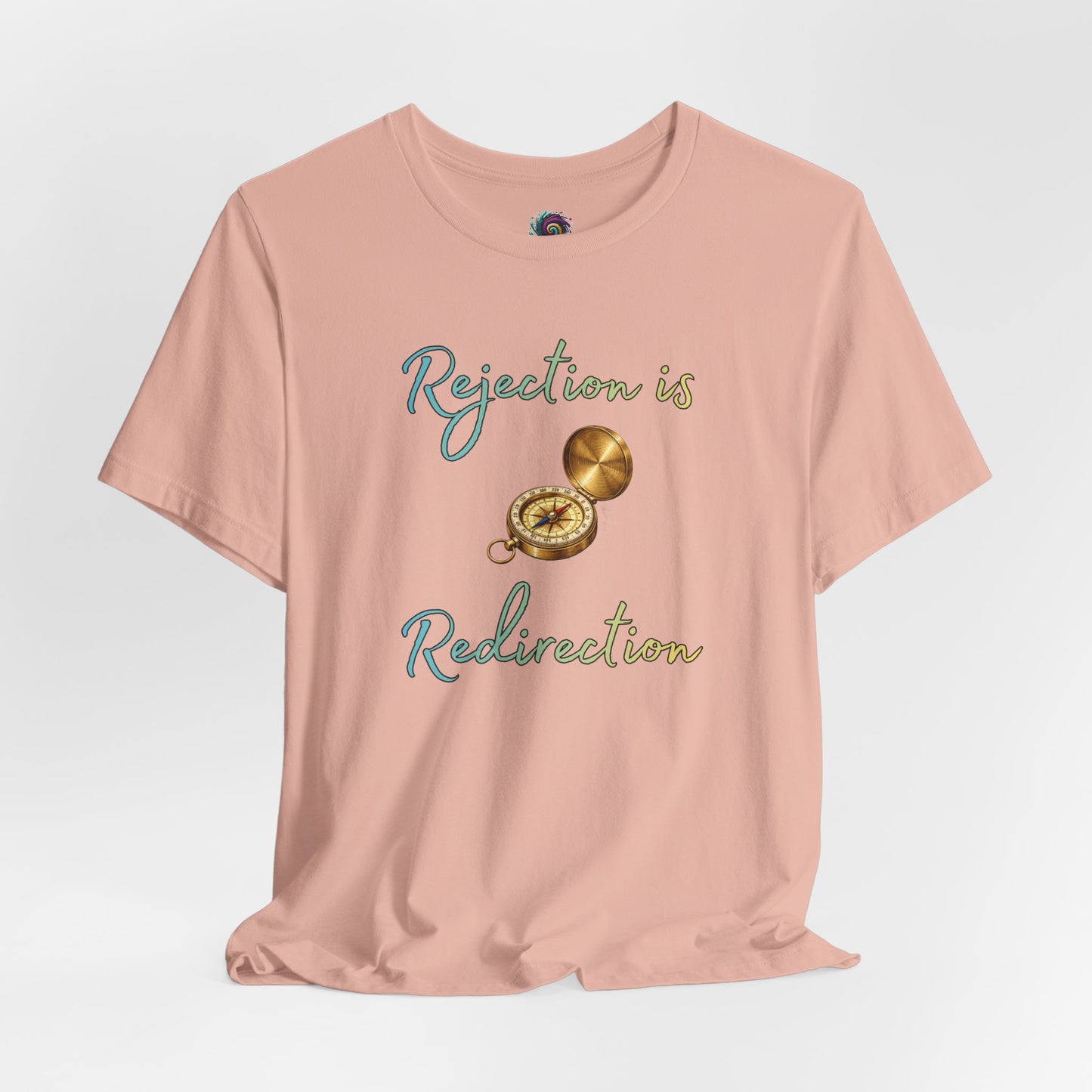 Rejection Is Redirection T-Shirt – Motivational Compass Quote Tee in peach with compass graphic and rejection motivational shirt message