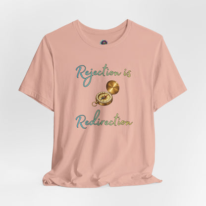 Rejection Is Redirection T-Shirt – Motivational Compass Quote Tee in peach with compass graphic and rejection motivational shirt message