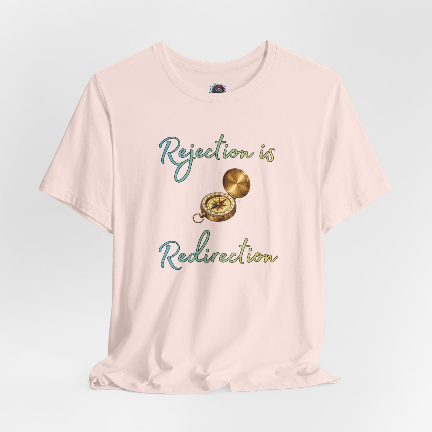 Rejection Is Redirection T-Shirt – Motivational Compass Quote Tee in soft pink featuring the rejection is redirection shirt quote with compass graphic