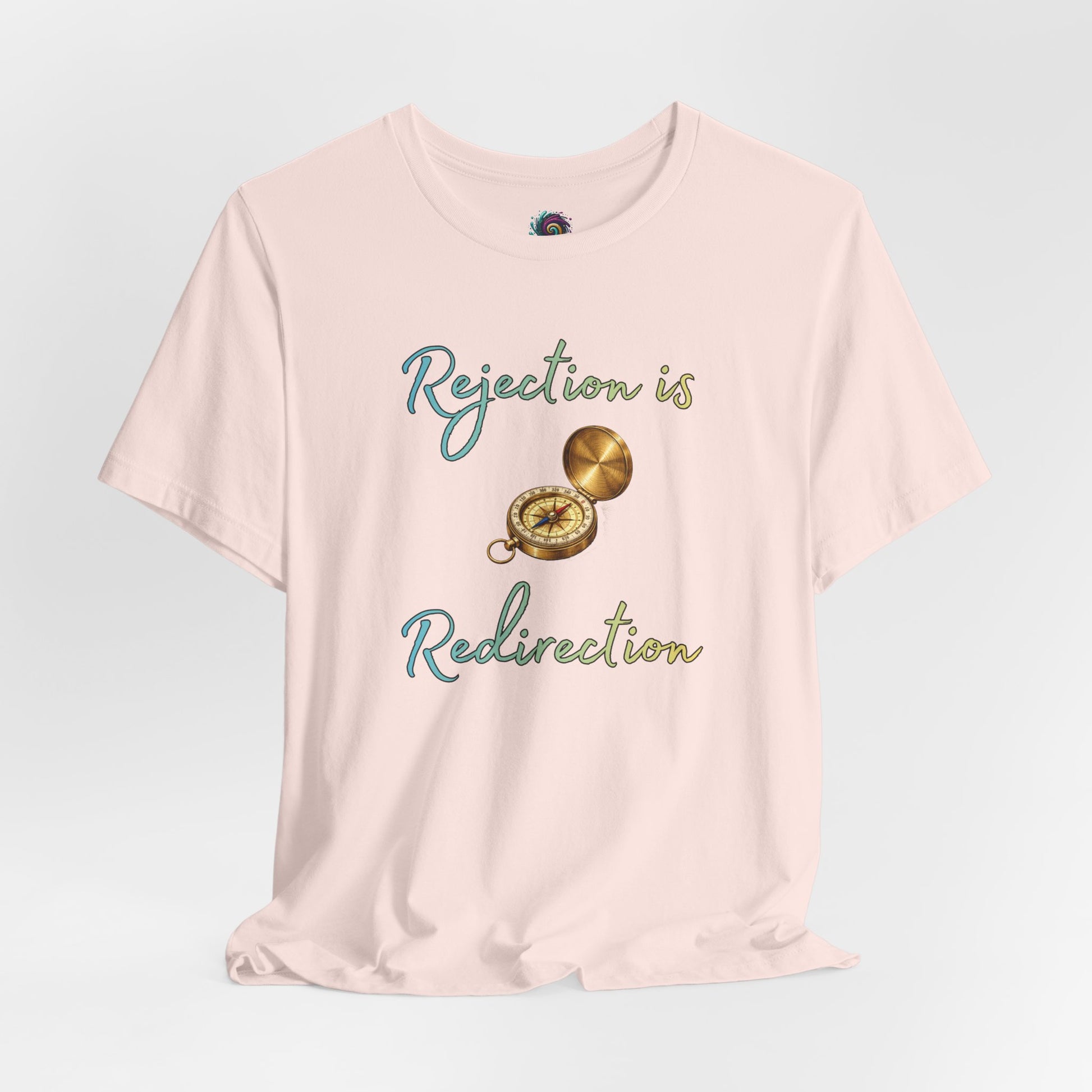 Rejection Is Redirection T-Shirt – Motivational Compass Quote Tee in soft pink featuring the rejection is redirection shirt quote with compass graphic