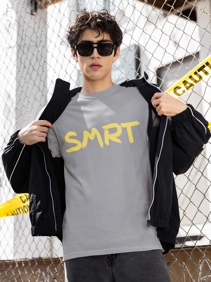 Man revealing grey SMRT T-Shirt with bold yellow SMRT text while standing in front of caution-taped fence