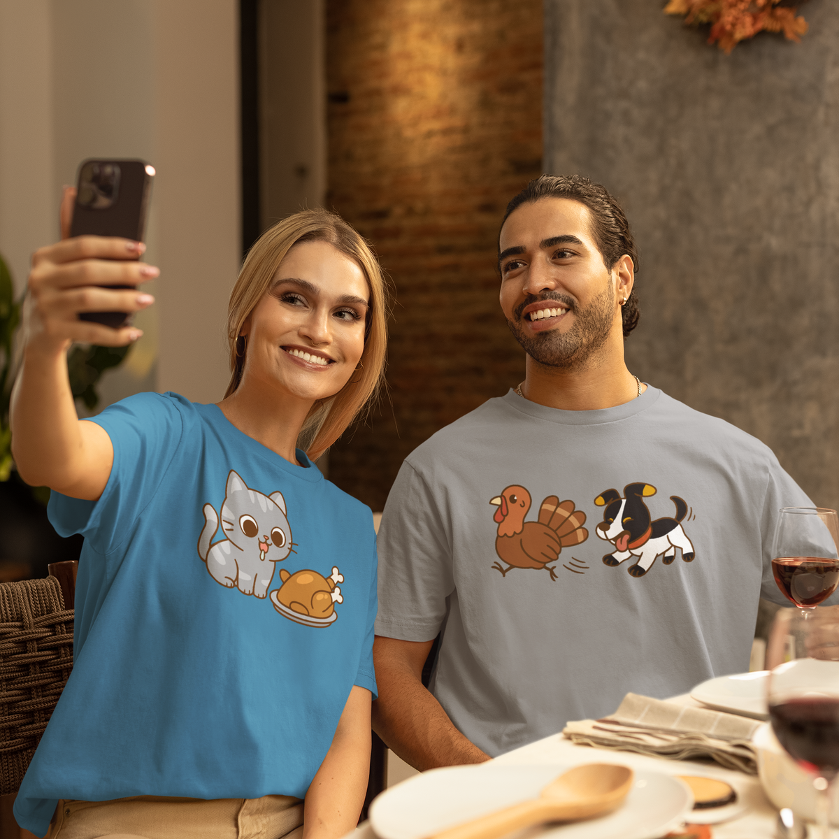 Thanksgiving Cat T-Shirt – Cute Hungry Cat and Turkey Tee in Columbia Blue worn by woman taking selfie at Thanksgiving dinner table