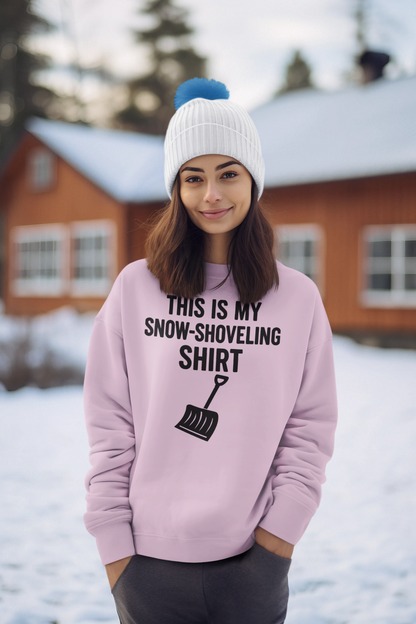 This Is My Snow-Shoveling Shirt – Funny Winter Chore Sweatshirt worn by a woman in a snowy lodge setting, showcasing the playful snow shovel design during cold winter weather