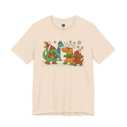 the Dinosaur Snowball Fight T-Shirt – Funny Winter Dino Graphic Tee in Soft Cream, pairing warm fabric tones with playful winter dinosaur art.