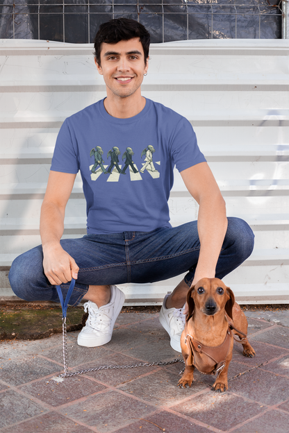Cthulhu Crossing T-Shirt – Beatles Abbey Road Parody Tee in steel blue, modeled outdoors with dachshund, playful Abbey Road parody t shirt featuring singer Cthulhu lineup.