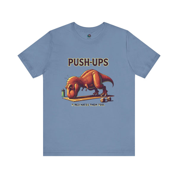 T-Rex Push-Up T-Shirt – Funny Dinosaur Workout Graphic Tee in steel blue featuring a lovable dino struggling with push ups – perfect for fitness jokesters.