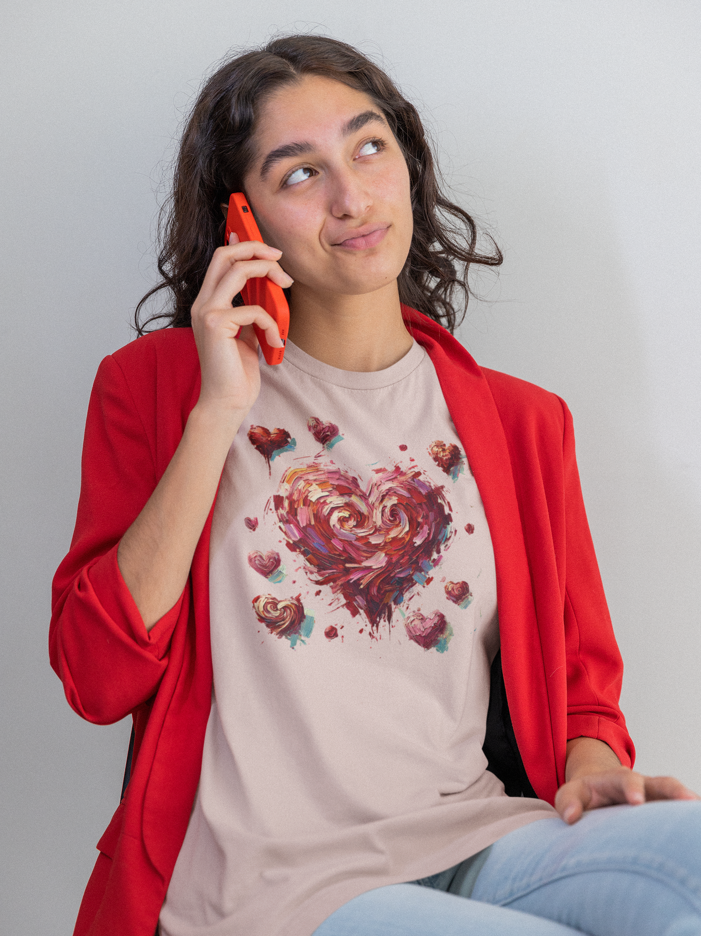 Woman in soft pink shirt and red blazer on phone wears Impressionistic Heart T-Shirt – Artistic Valentine's Day Tee