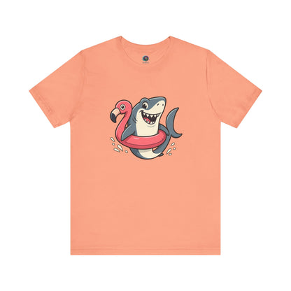 Shark Flamingo Floatie T-Shirt – Funny Beach & Pool Day Tee in sunset orange with quirky beach shark and floatie print
