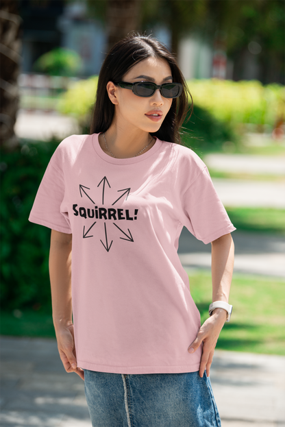 Squirrel Distracted Mind T-Shirt – Funny Attention Graphic Tee in pink worn outdoors in sunlight, showcasing a playful distraction theme and squirrel brain humor in a stylish setting.