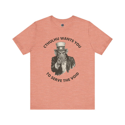 Pink t-shirt with graphic design and text 'Cthulhu wants you to serve the void' on a white background