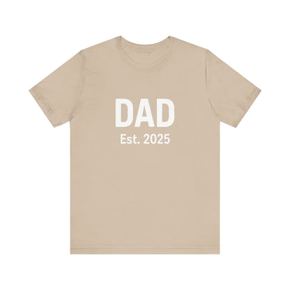 Dad Est. 2025 T-Shirt – New Dad Shirt, First Father’s Day Gift, Pregnancy Announcement Tee in tan flat lay for soft neutral tones