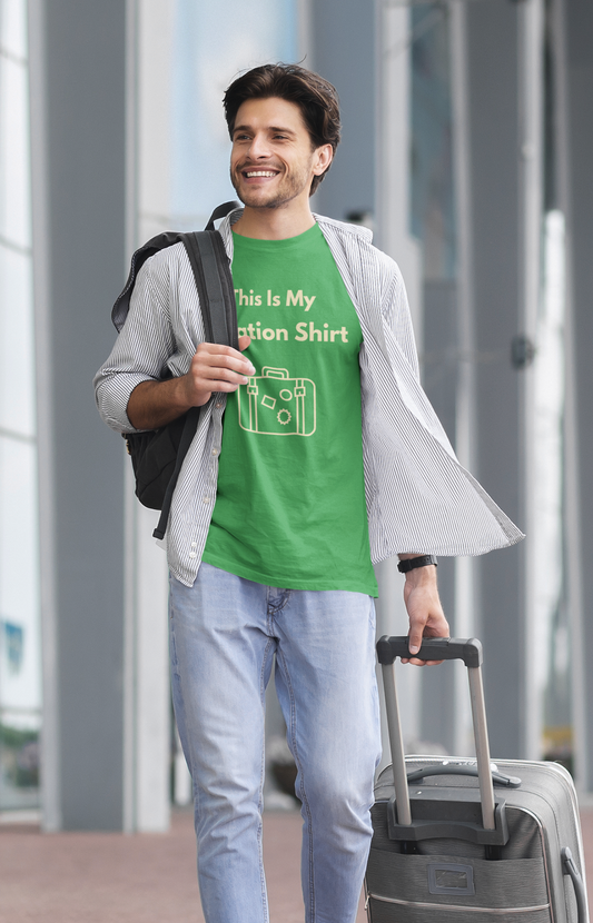 A man wearing a green tshirt with yellow text that says "This is my vacation shirt" with a yellow outline graphic od a suitcase. 