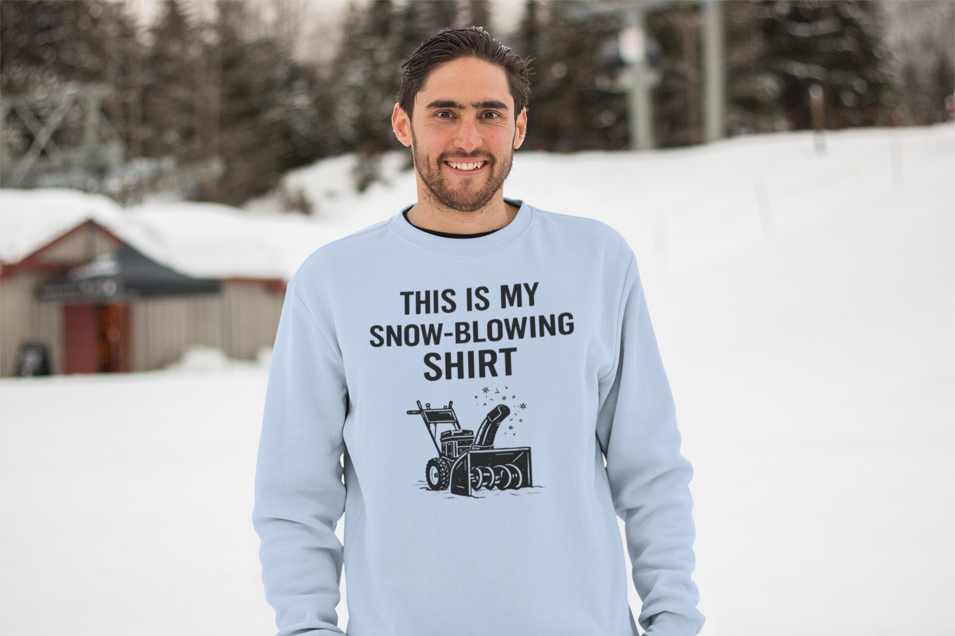 This Is My Snow-Blowing Shirt – Funny Winter Chore Sweatshirt shown outdoors in snow, featuring a light blue tone and a humorous take on snow blowing during winter storms.