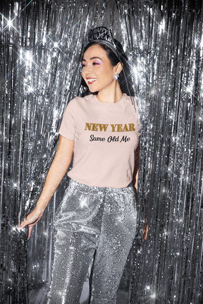 Image of a woman wearing the New Year Same Old Me T-Shirt – Funny Self-Confidence Tee with a festive headband and sequined pants, smiling against a silver tinsel backdrop.