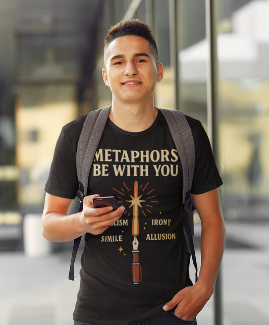 a college aged man wearing a black Metaphors Be With You T-Shirt – Inspired by Sci-Fi & Lit Class Heroes shirt from WhimSpin standing outdoors. the graphic features a fountain pen with a ray of light coming from the nib like a light saber and the words "Metaphors Be With You" over top