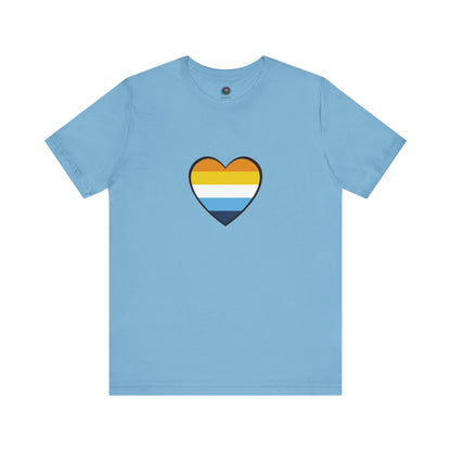 AroAce Flag Heart T-shirt from WhimSpin. The shirt is turquoise with an aroace heart drawn in the center made up of dark orange, light orange, white, turquoise, and navy blue stripes.