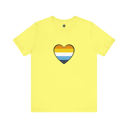 Light Yellow AroAce Flag Heart T-shirt from WhimSpin. The shirt is light yellow with a heart drawn in the center made up of dark orange, light orange, white, turquoise, and navy blue stripes.