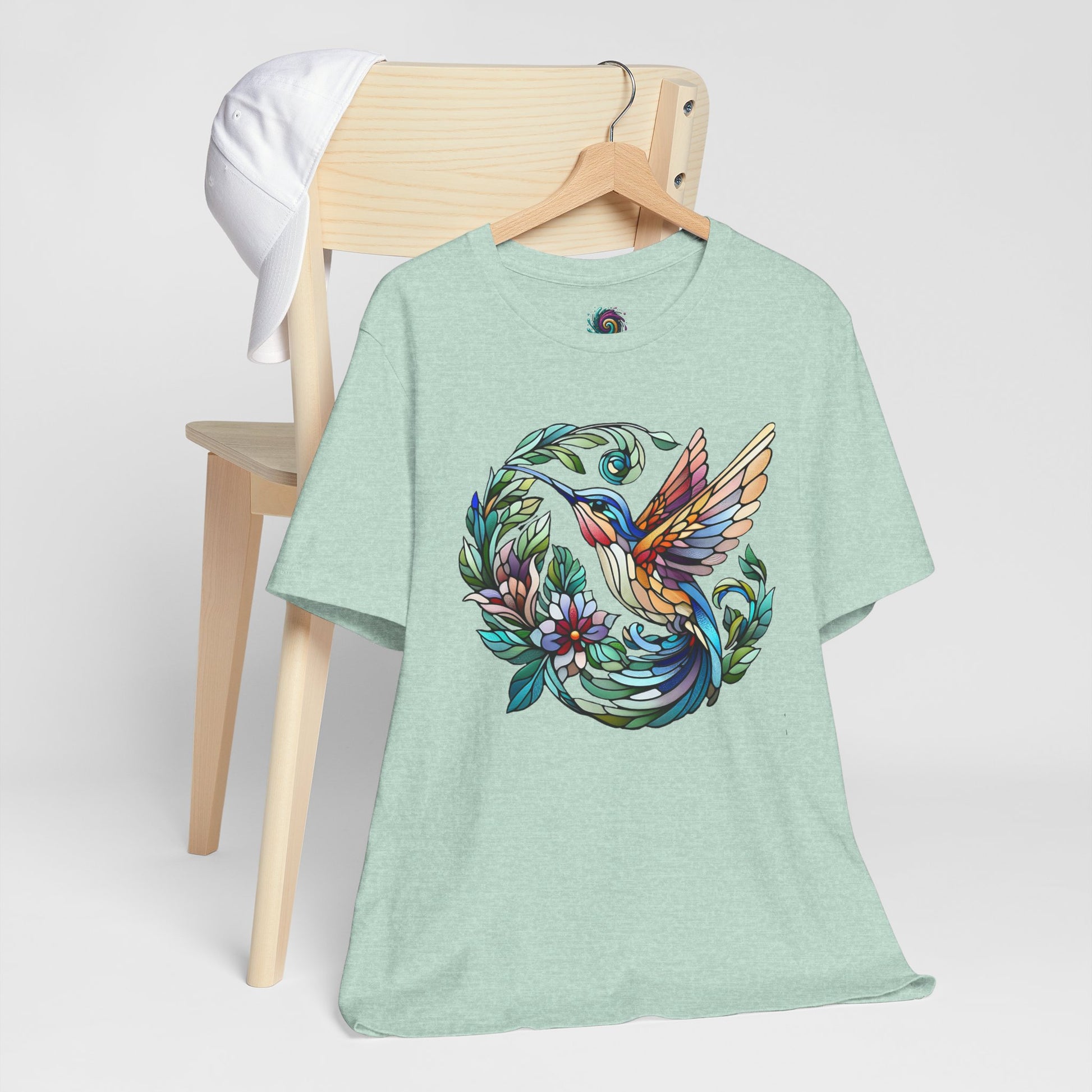 Stained Glass Hummingbird T-Shirt – Colorful Floral Bird Graphic Tee in heather prism mint featuring a stained glass hummingbird and ring of leaves and flowers